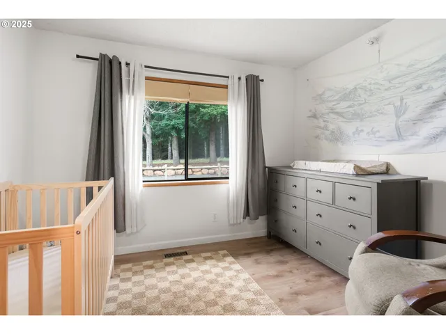 a kitchen with a wooden floor and white walls