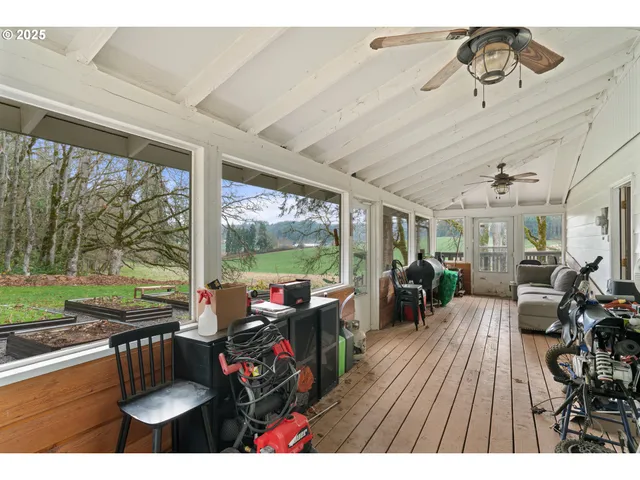 a view of balcony with wooden floor and fence