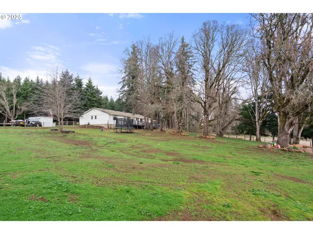 a swimming pool with trees in the background