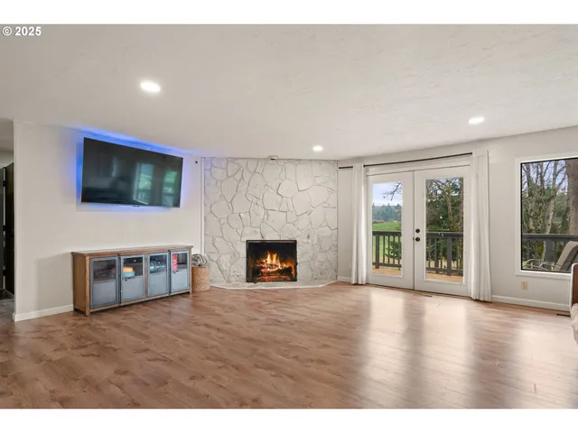 a view of an empty room with a fireplace and a window
