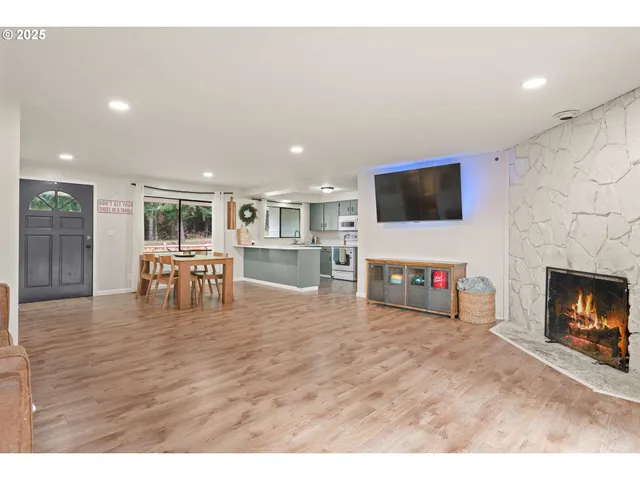 a living room with furniture a fireplace and a flat screen tv