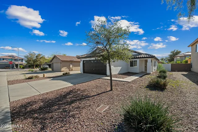 a view of a house with a yard and garage
