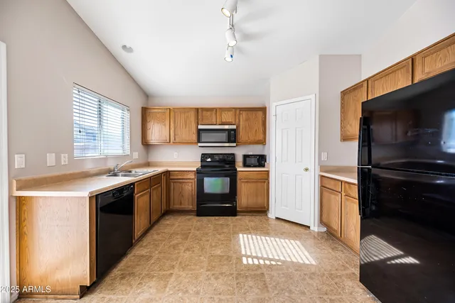 a kitchen with a refrigerator stove and sink