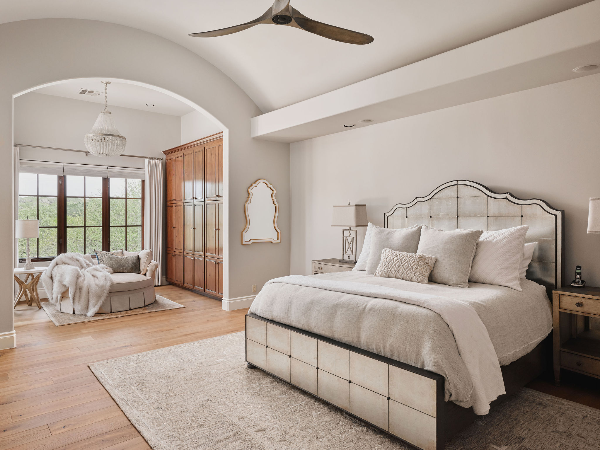 433 Brandon Way Austin, TX 78733 - Photo 13 of 40 An inviting primary bedroom featuring vaulted ceilings and polished hardwood flooring.