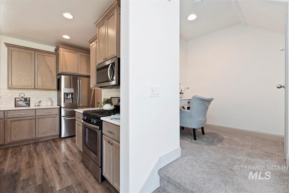 5932 West Quintale Drive Meridian, ID 83646 - Photo 14 of 40 Kitchen with stainless steel appliances, dark colored carpet, tasteful backsplash, and recessed lighting
