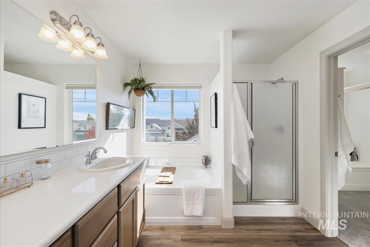 5932 West Quintale Drive Meridian, ID 83646 - Photo 26 of 40 Full bath with a garden tub, a stall shower, dark wood-style flooring, and healthy amount of natural light