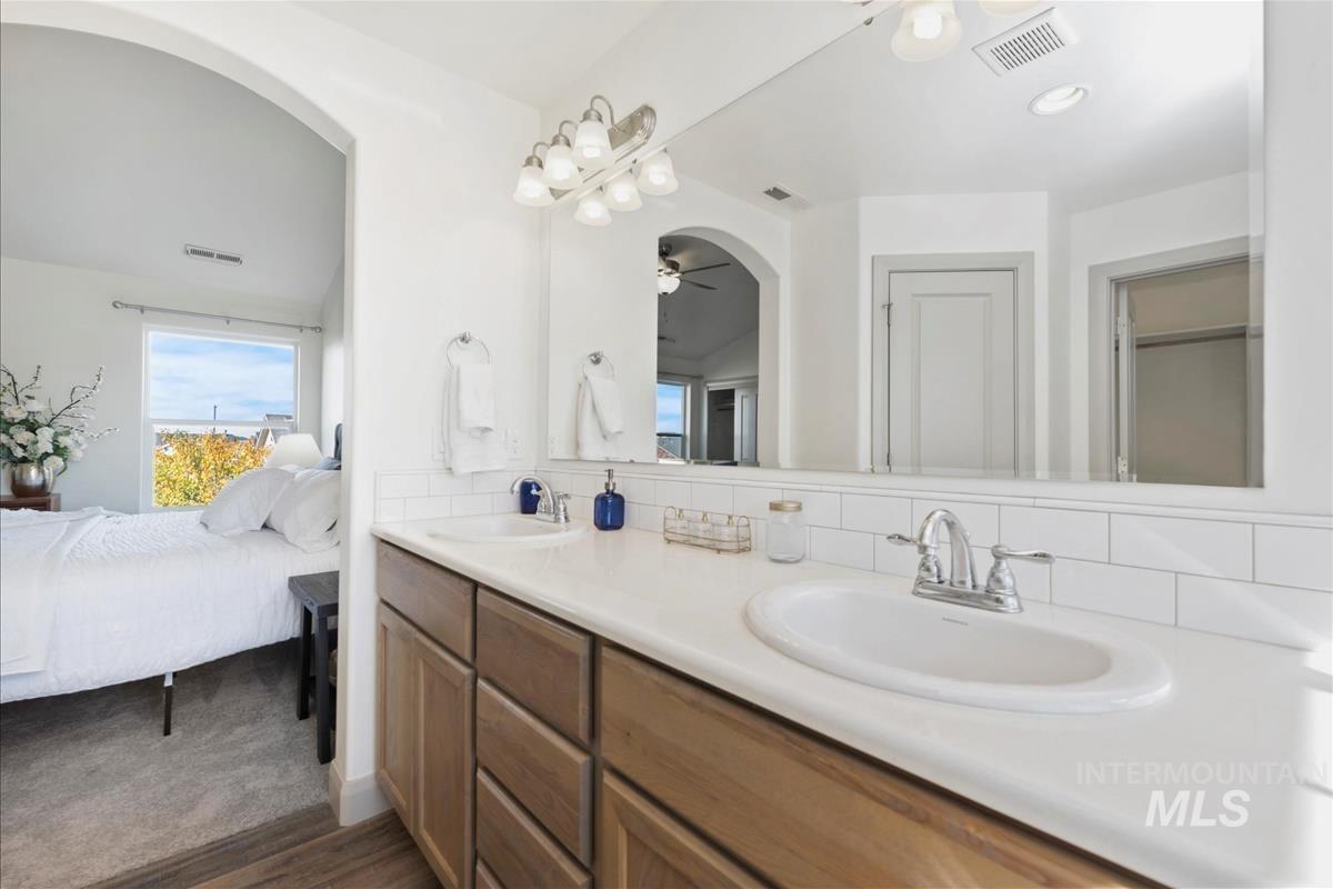 5932 West Quintale Drive Meridian, ID 83646 - Photo 28 of 40 Bathroom featuring double vanity, tasteful backsplash, ensuite bath, and a ceiling fan