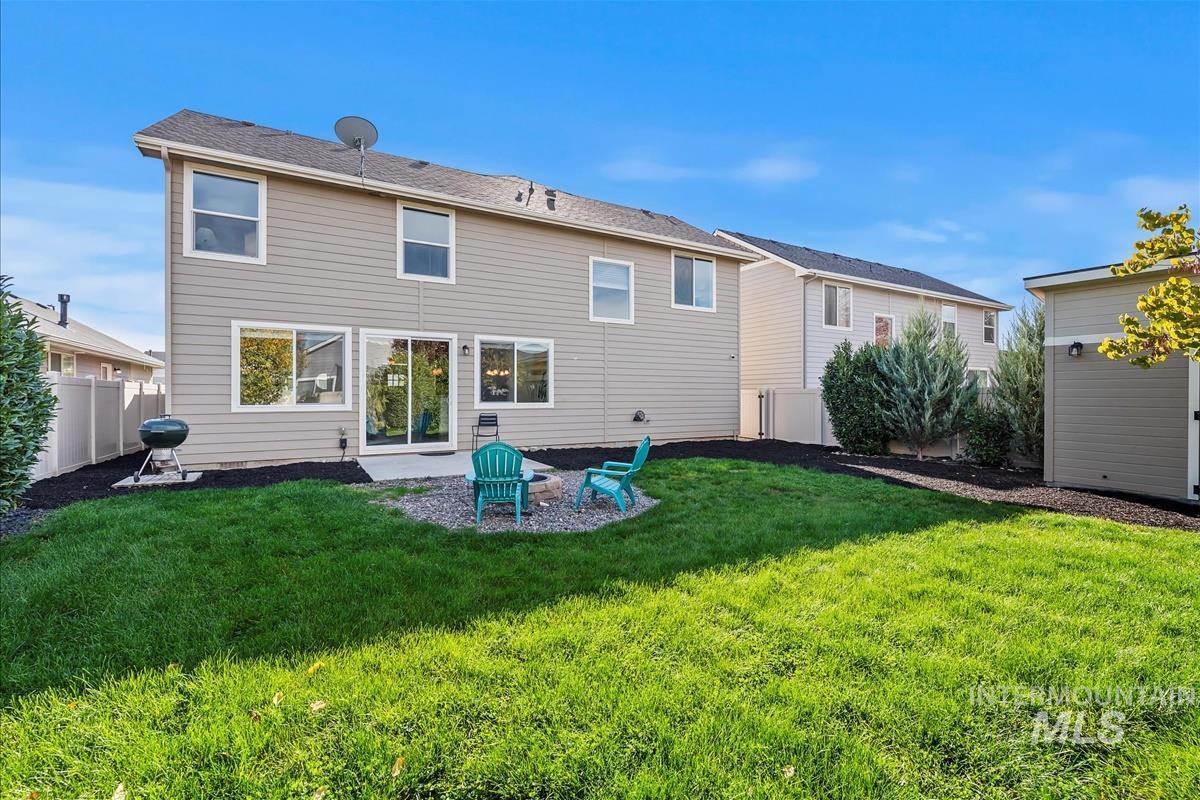 5932 West Quintale Drive Meridian, ID 83646 - Photo 30 of 40 Rear view of house with a fenced backyard and a patio