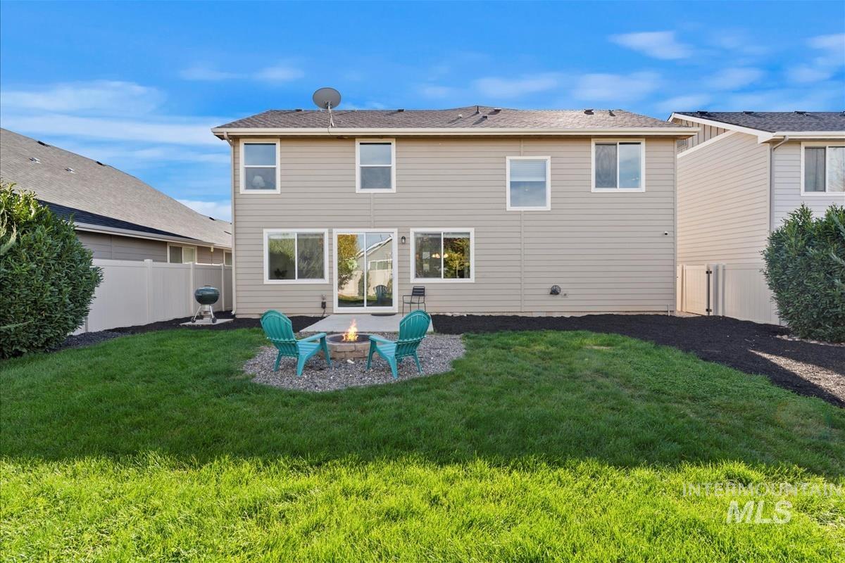 5932 West Quintale Drive Meridian, ID 83646 - Photo 31 of 40 Rear view of property with a patio area, a fire pit, and a fenced backyard