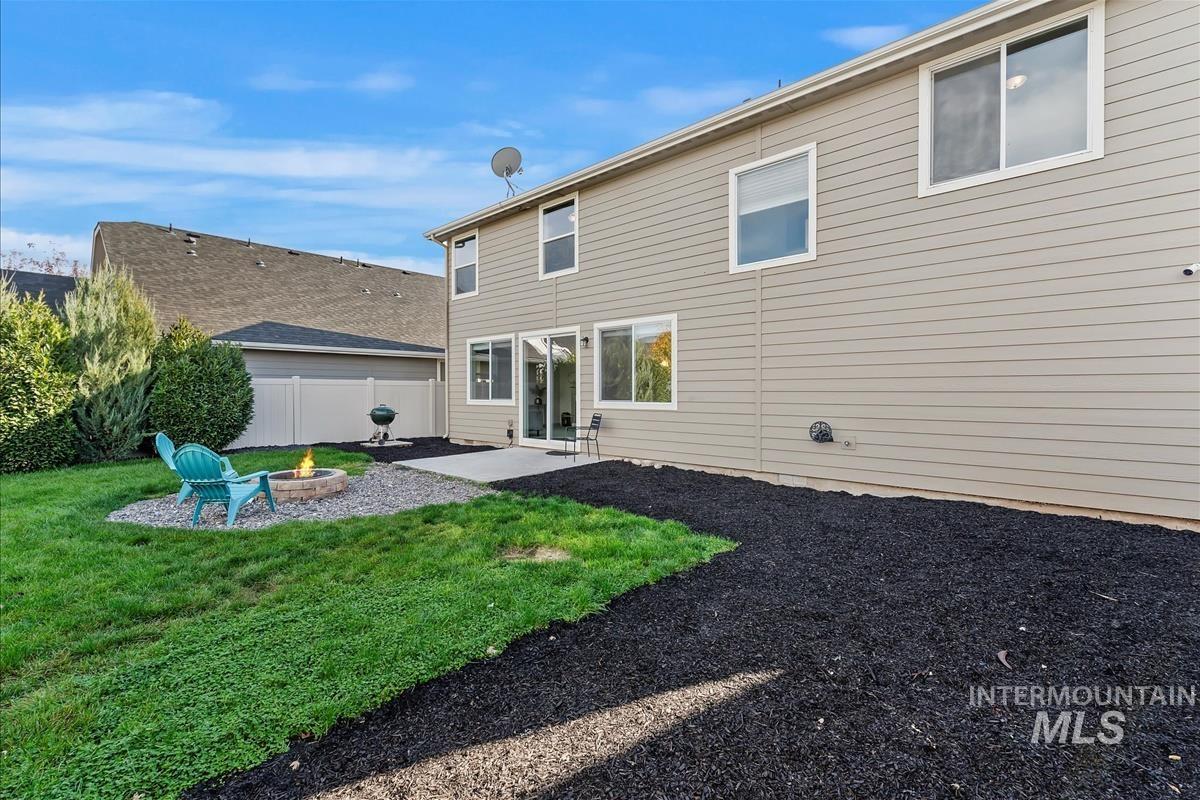 5932 West Quintale Drive Meridian, ID 83646 - Photo 33 of 40 Back of property featuring a patio area and a fire pit