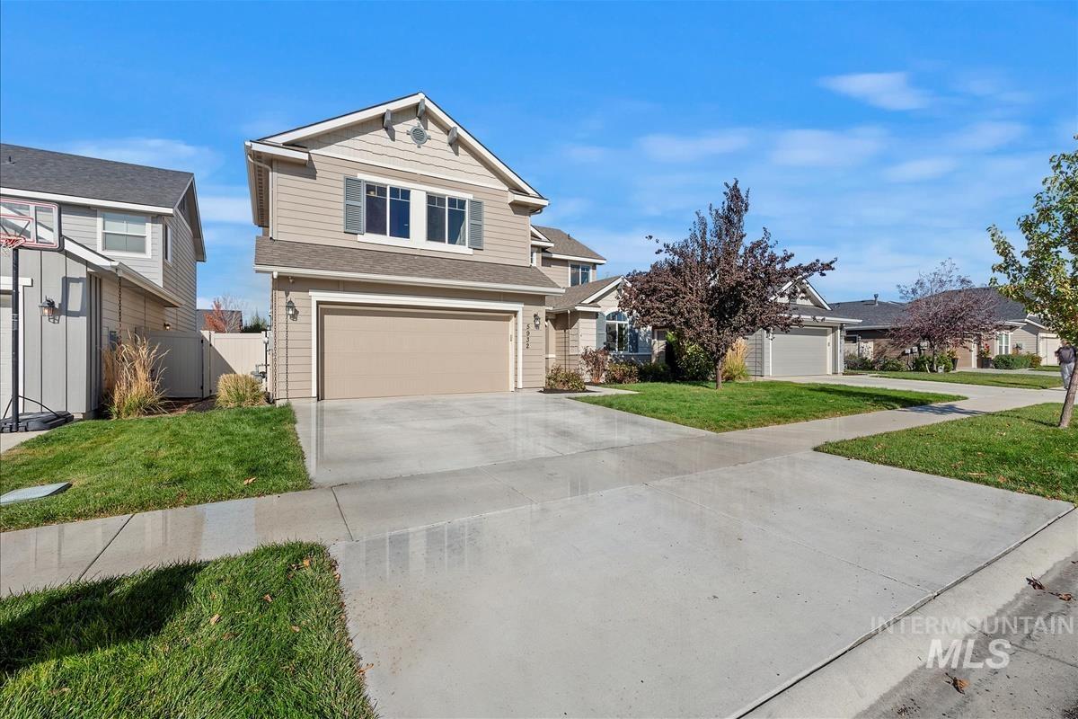 5932 West Quintale Drive Meridian, ID 83646 - Photo 34 of 40 View of front of home featuring driveway, a garage, a shingled roof, and a residential view