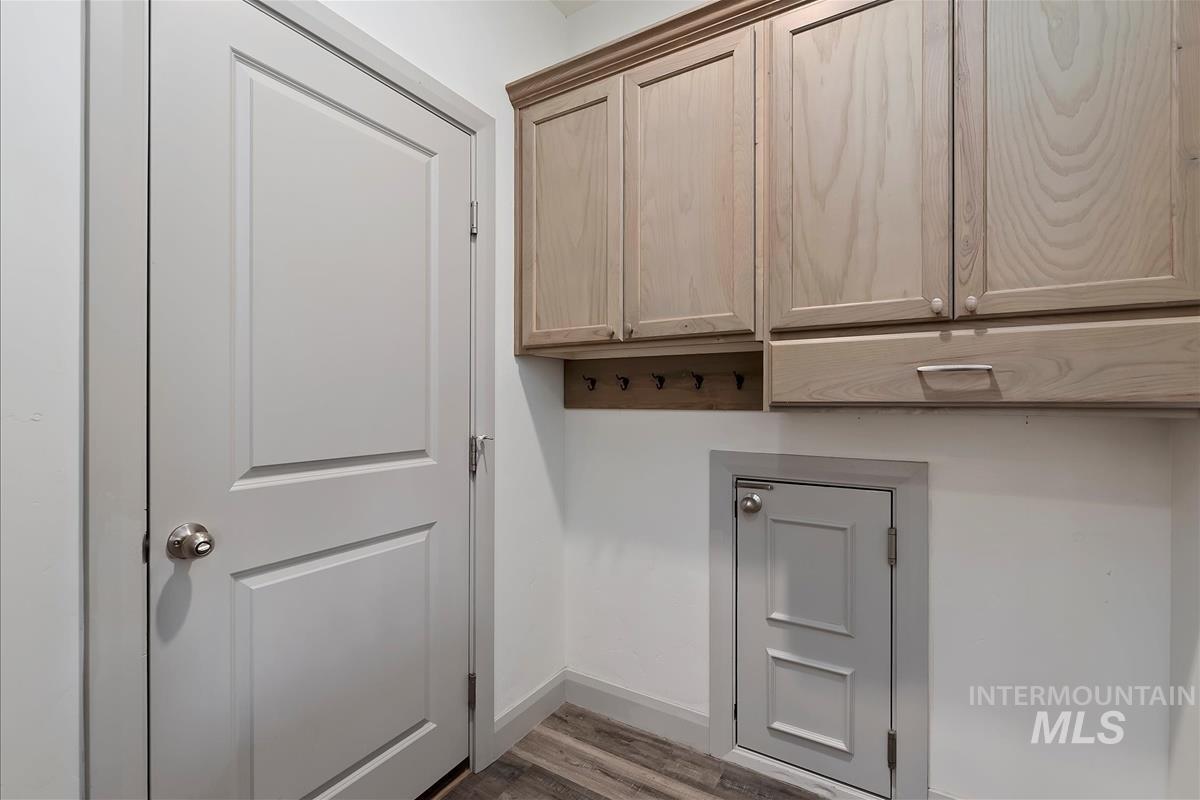 5932 West Quintale Drive Meridian, ID 83646 - Photo 36 of 40 Door between garage and home with discrete dog door into garage to dog run. Mud room has hooks and cabinets.