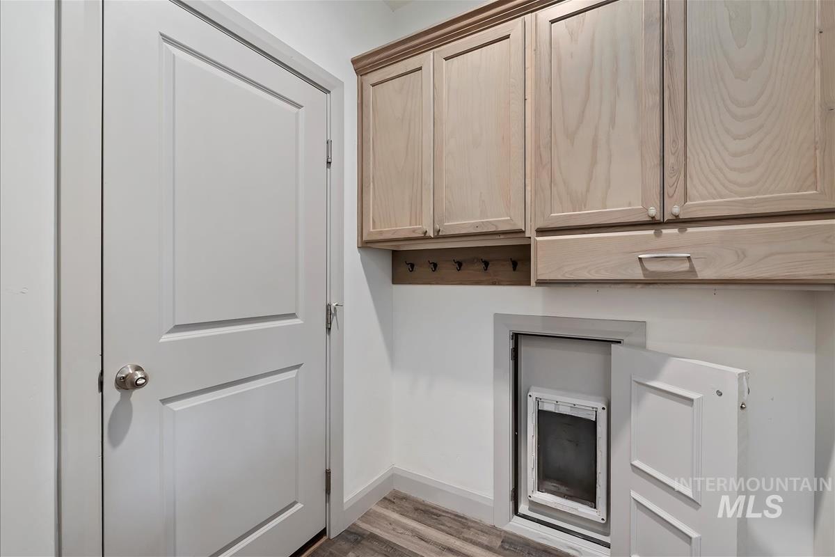 5932 West Quintale Drive Meridian, ID 83646 - Photo 37 of 40 Door between garage and home with discrete dog door into garage to dog run. Mud room has hooks and cabinets.