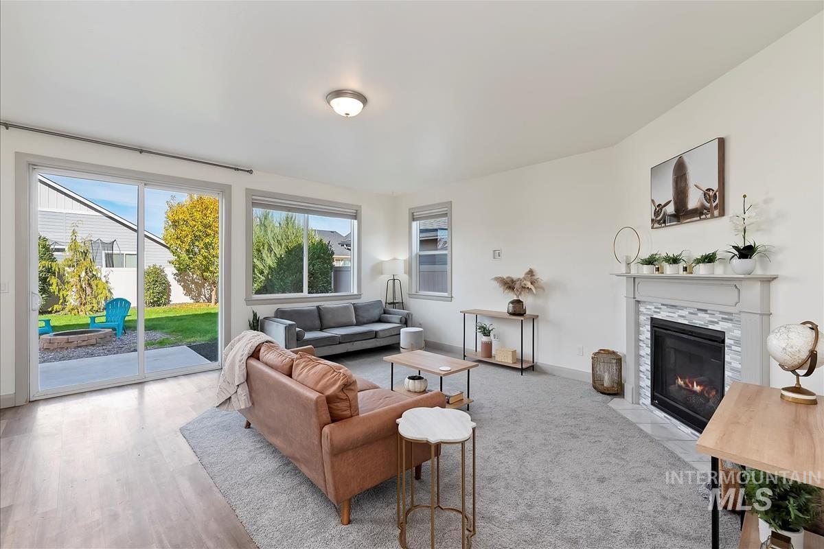 5932 West Quintale Drive Meridian, ID 83646 - Photo 6 of 40 Living area with a tiled fireplace and baseboards