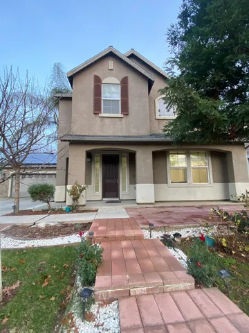 a front view of a house with yard