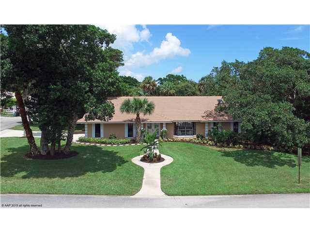 9 West High Point Road Stuart, FL 34996 - Photo 1 of 25 a front view of a house with a yard