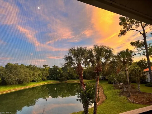a view of a lake with houses in the back