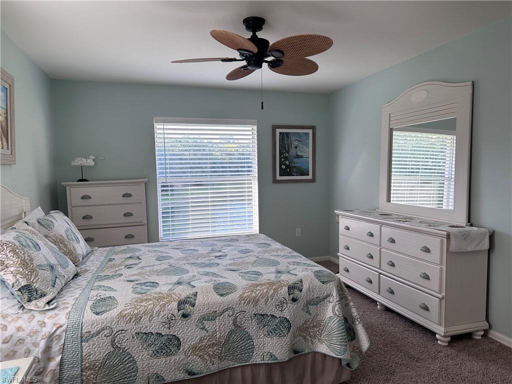 321 Robin Hood Circle, Unit 201 Naples, FL 34104 - Photo 11 of 28 a bedroom with a bed and a dresser