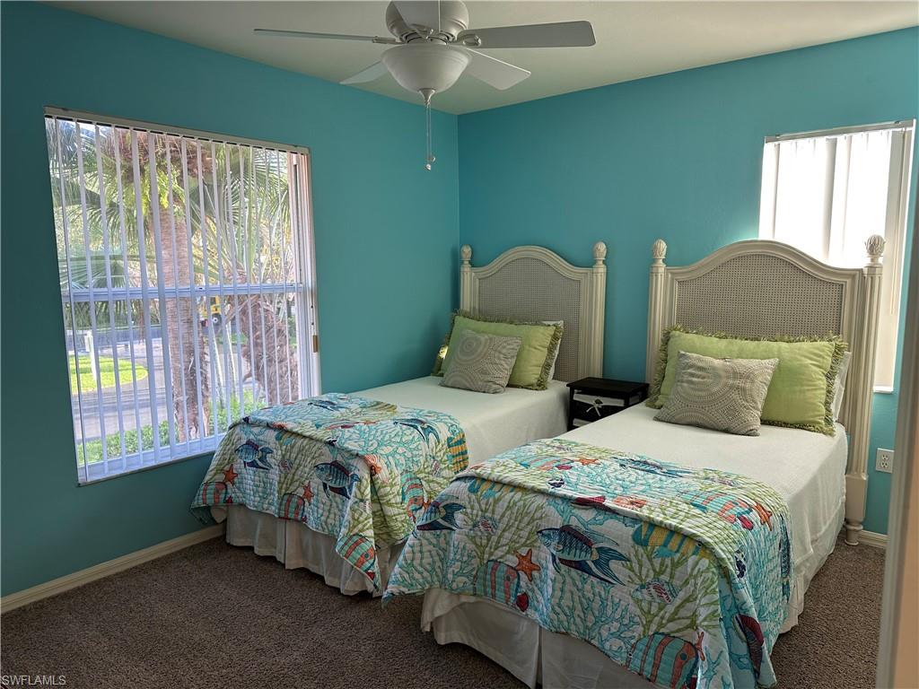 321 Robin Hood Circle, Unit 201 Naples, FL 34104 - Photo 13 of 28 a bedroom with two beds and a window