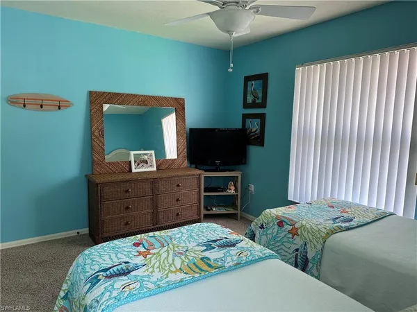 a bedroom with a bed and a mirror on dresser