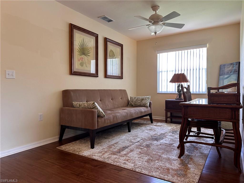 321 Robin Hood Circle, Unit 201 Naples, FL 34104 - Photo 15 of 28 a living room with furniture a window and a piano