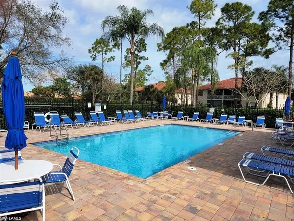 a view of a swimming pool with outdoor seating