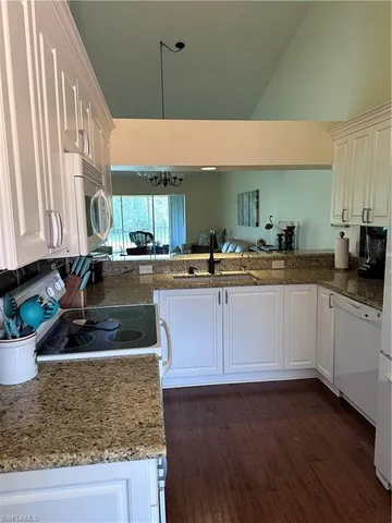 a kitchen with stainless steel appliances granite countertop wooden cabinets a sink and dishwasher