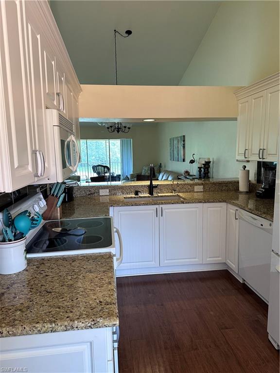 321 Robin Hood Circle, Unit 201 Naples, FL 34104 - Photo 5 of 28 a kitchen with stainless steel appliances granite countertop wooden cabinets a sink and dishwasher
