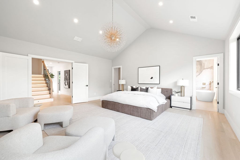 45 East Quinobequin Road Newton, MA 02462 - Photo 28 of 40 a spacious bedroom with a large bed and a chandelier
