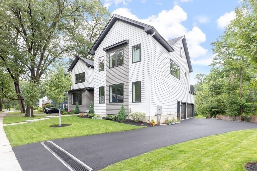 45 East Quinobequin Road Newton, MA 02462 - Photo 3 of 40 a front view of a house with a yard and trees