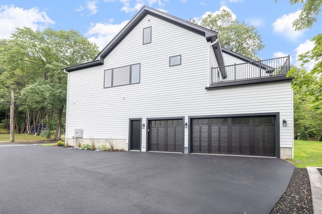 45 East Quinobequin Road Newton, MA 02462 - Photo 9 of 40 a view of a house with a yard and garage