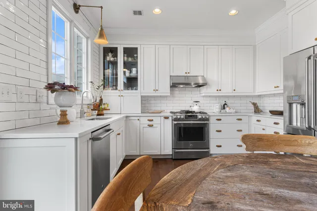 a kitchen with a sink stove and cabinets