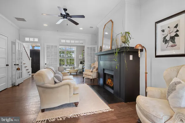 a living room with furniture fireplace and a large window