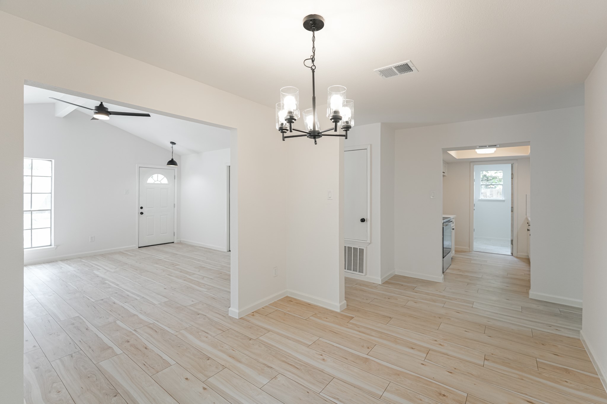 5311 Oaklynn Drive Spring, TX 77373 - Photo 13 of 33 a view of a livingroom with wooden floor staircase and a chandelier