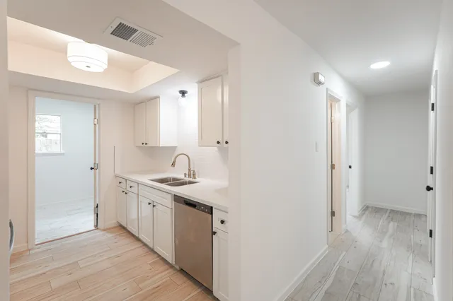 a view of a kitchen from a hallway