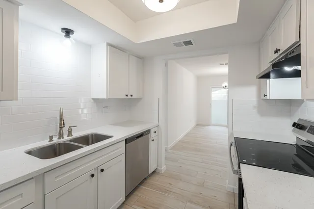 a kitchen with a sink and cabinets