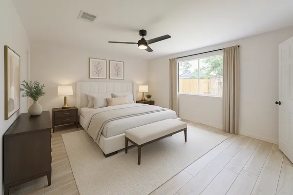 a bedroom with a large bed chandelier and a window