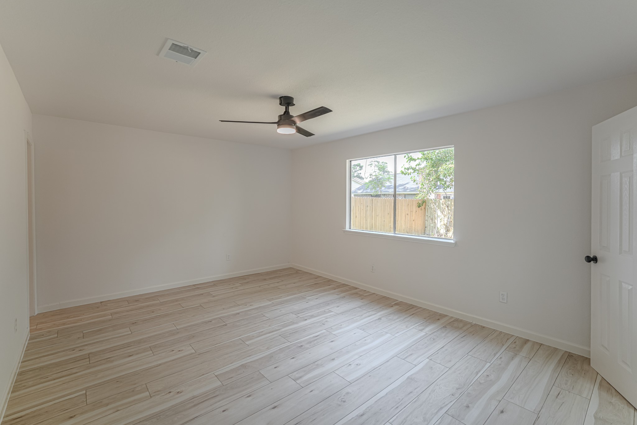 5311 Oaklynn Drive Spring, TX 77373 - Photo 19 of 33 a view of empty room with wooden floor and fan