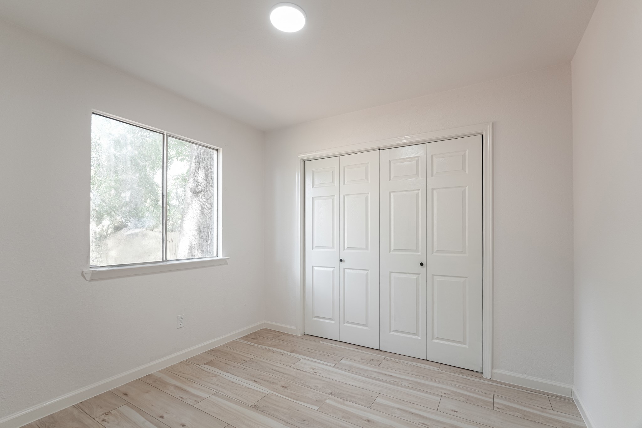 5311 Oaklynn Drive Spring, TX 77373 - Photo 25 of 33 an empty room with wooden floor and windows