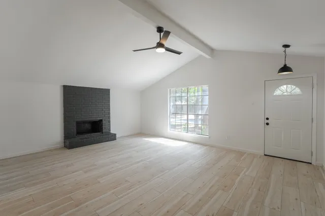 wooden floor in an empty room with a window
