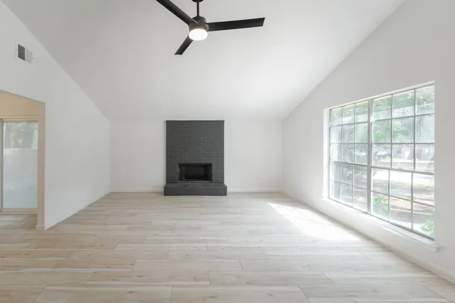 an empty room with windows and closet