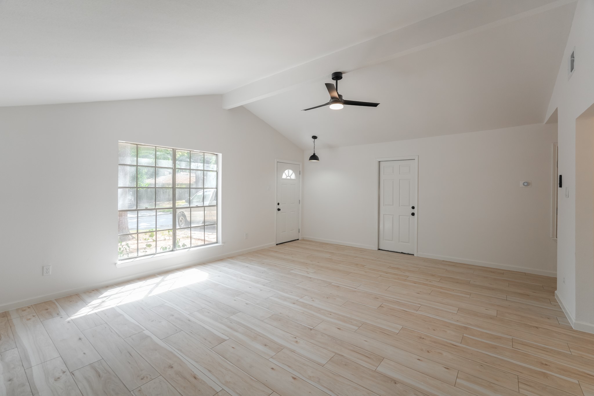 5311 Oaklynn Drive Spring, TX 77373 - Photo 9 of 33 a view of an empty room with a window and wooden floor