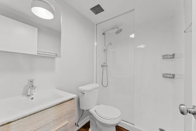 a white toilet sitting next to a bathroom sink
