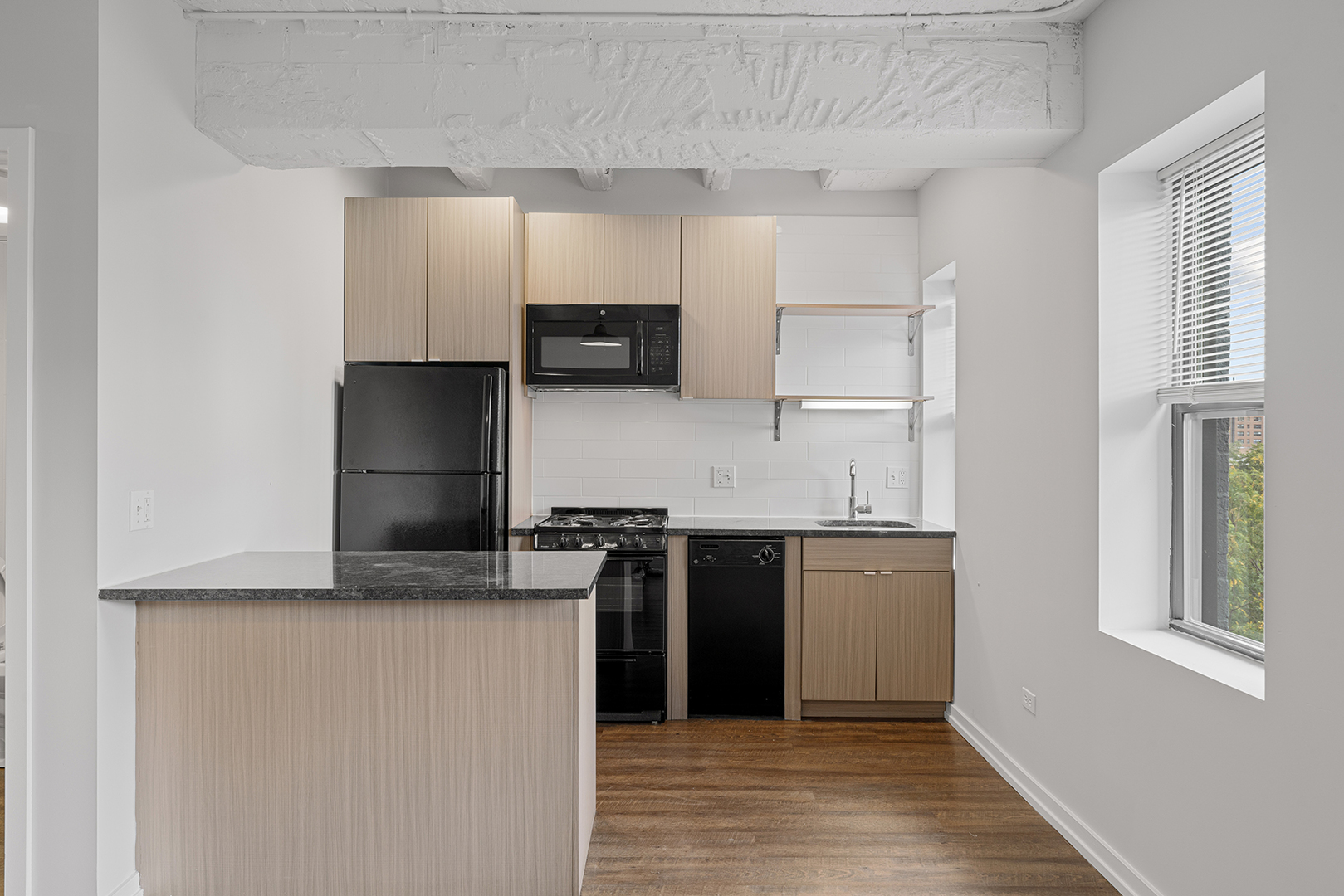 5718 North Winthrop Avenue, Unit 802 Chicago, IL 60660 - Photo 5 of 16 a kitchen with kitchen island granite countertop a stove and a refrigerator