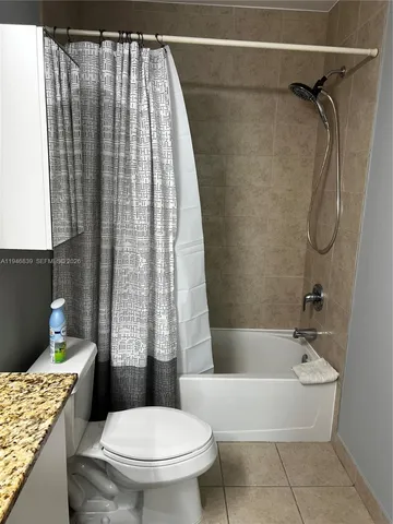 a bathroom with a toilet and shower