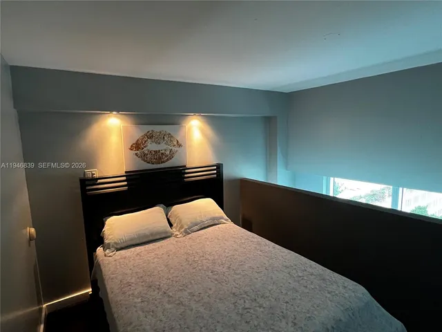 a bed room with furniture and a night stand