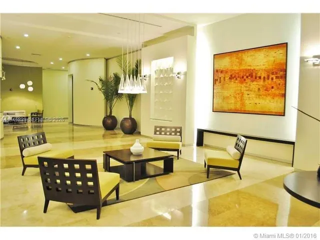 a living room with a couch and a potted plant