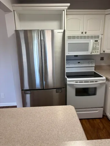 a kitchen with appliances and cabinets