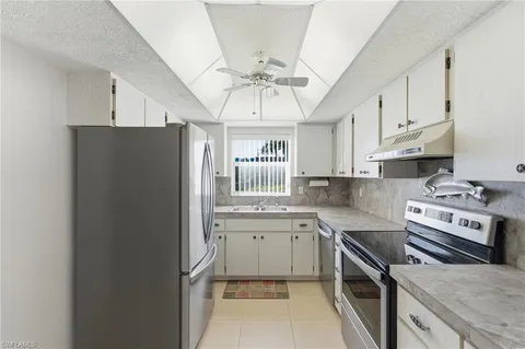 a kitchen with stainless steel appliances a sink stove and refrigerator