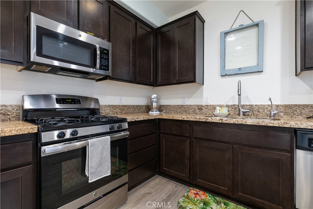 9354 Riberena Circle Atascadero, CA 93422 - Photo 8 of 47 a kitchen with stainless steel appliances granite countertop a stove and a microwave